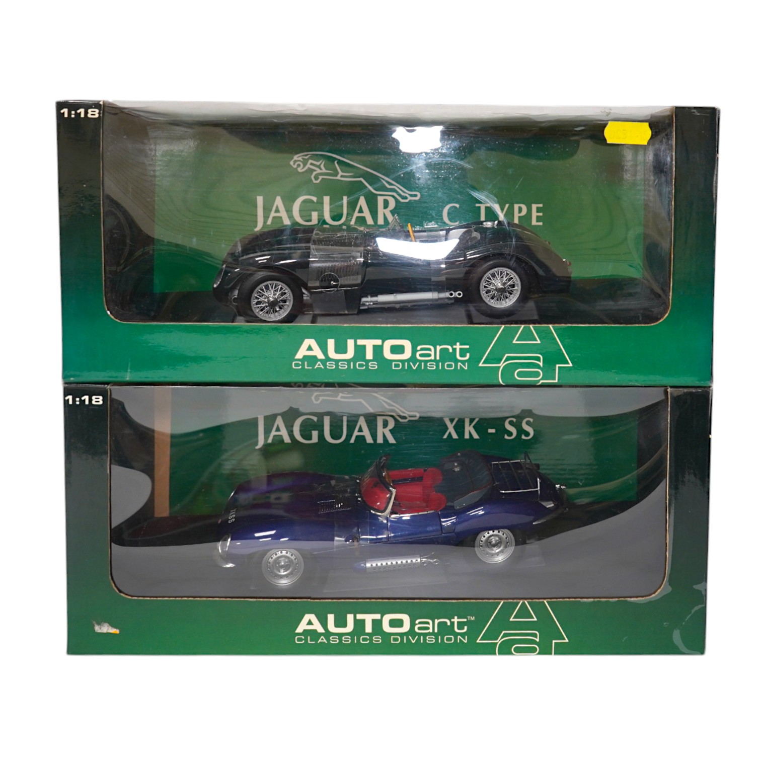 Two boxed AutoArt Classics Division 1:18 scale diecast cars; a Jaguar XKSS and a Jaguar C Type. Condition - good.